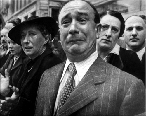 W. Eugene Smith  (December 30, 1918 – October 15, 1978), an American photojournalist known for his refusal to compromise professional standards and his brutally vivid World War II photographs - Frenchman weeps as German soldiers march into Paris - June-14-1940