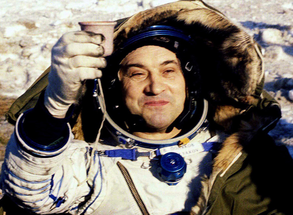 Russian cosmonaut Valeri Polyakov toasts with a cup of hot tea as he sits in an armchair after being taken out of the TM-20 landing unit which landed in northeast Arkalyk, Kazakhstan on March 22, 1995