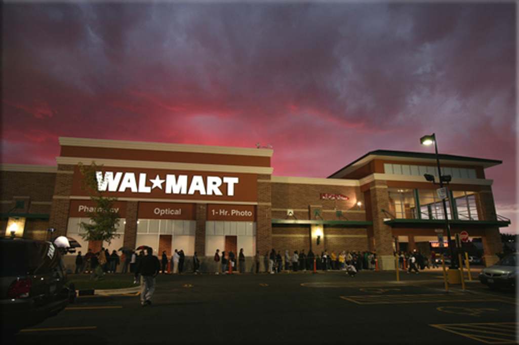 The first Wal-Mart store opens for business in Rogers, Arkansas