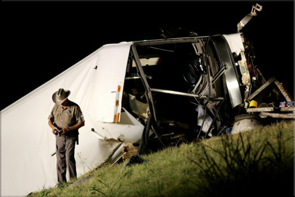 August 8, 2008; a Texas state trooper makes photographs at a bus accident scene on U.S. 75 North bound that killed several people in Sherman, Texas. Associated Press.