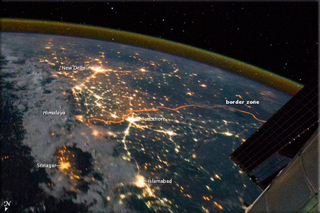 2012 India blackouts: India’s northwestern boundary with neighboring Pakistan is so brightly lit that the thin orange line tracing its path can be seen from space. NASA/EO