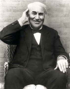 Thomas Edison smiling as he holds his hand to his ear, credit National Parks Service