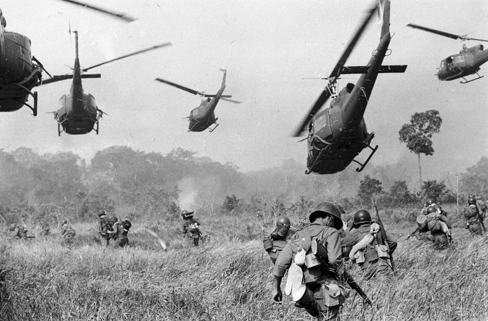 Vietnam War: Hovering U.S. Army helicopters pour machine gun fire into a tree line to cover the advance of South Vietnamese ground troops in an attack on a Viet Cong camp 18 miles north of Tay Ninh, northwest of Saigon near the Cambodian border, in Vietnam on March 1965