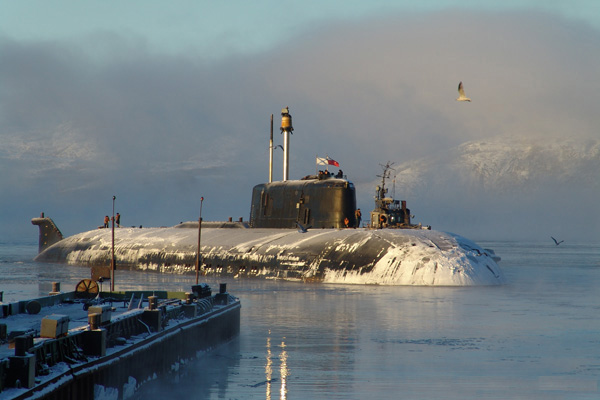 Oscar class submarine K-141 Kursk of the Russian Navy explodes and sinks in the Barents Sea during a military exercise
