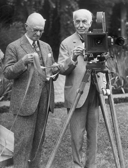Thomas Edison (right) demonstrating the kinetograph (motion picture camera), with the assistance of George Eastman, who helped develop the film used in the early motion picture machines