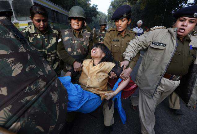 Policewomen remove a protester during a demonstration against the Delhi gang-rape, in New Delhi. AP